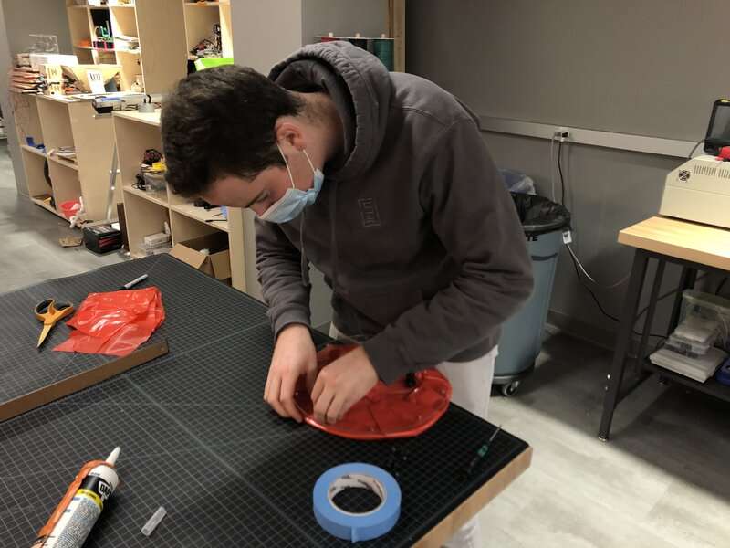 A teammate assembling a buoy